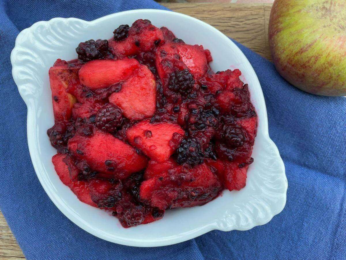 Stewed blackberry and apple in white dish.