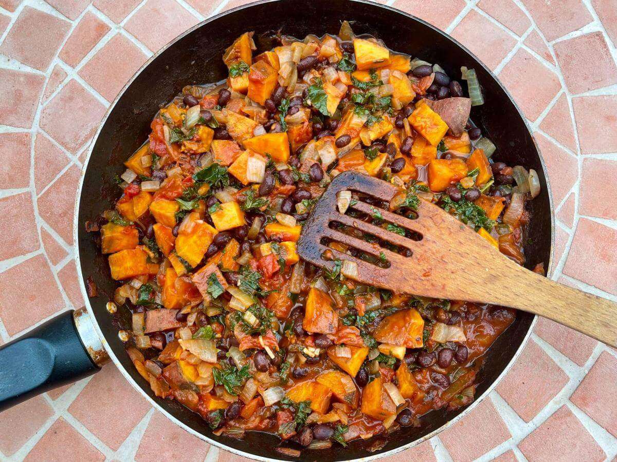 Sweet potato stew with kale in pan.
