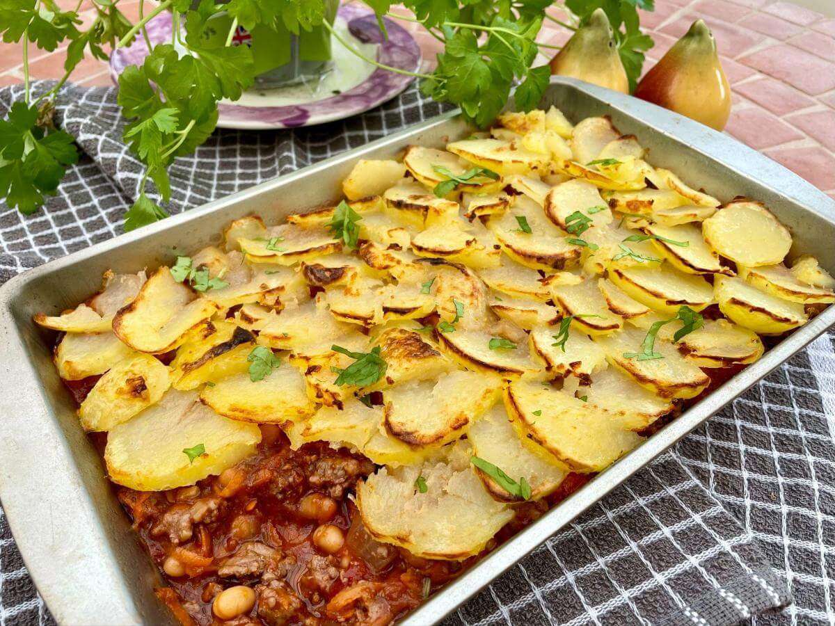 Beef and bean hotpot with layered potatoes.