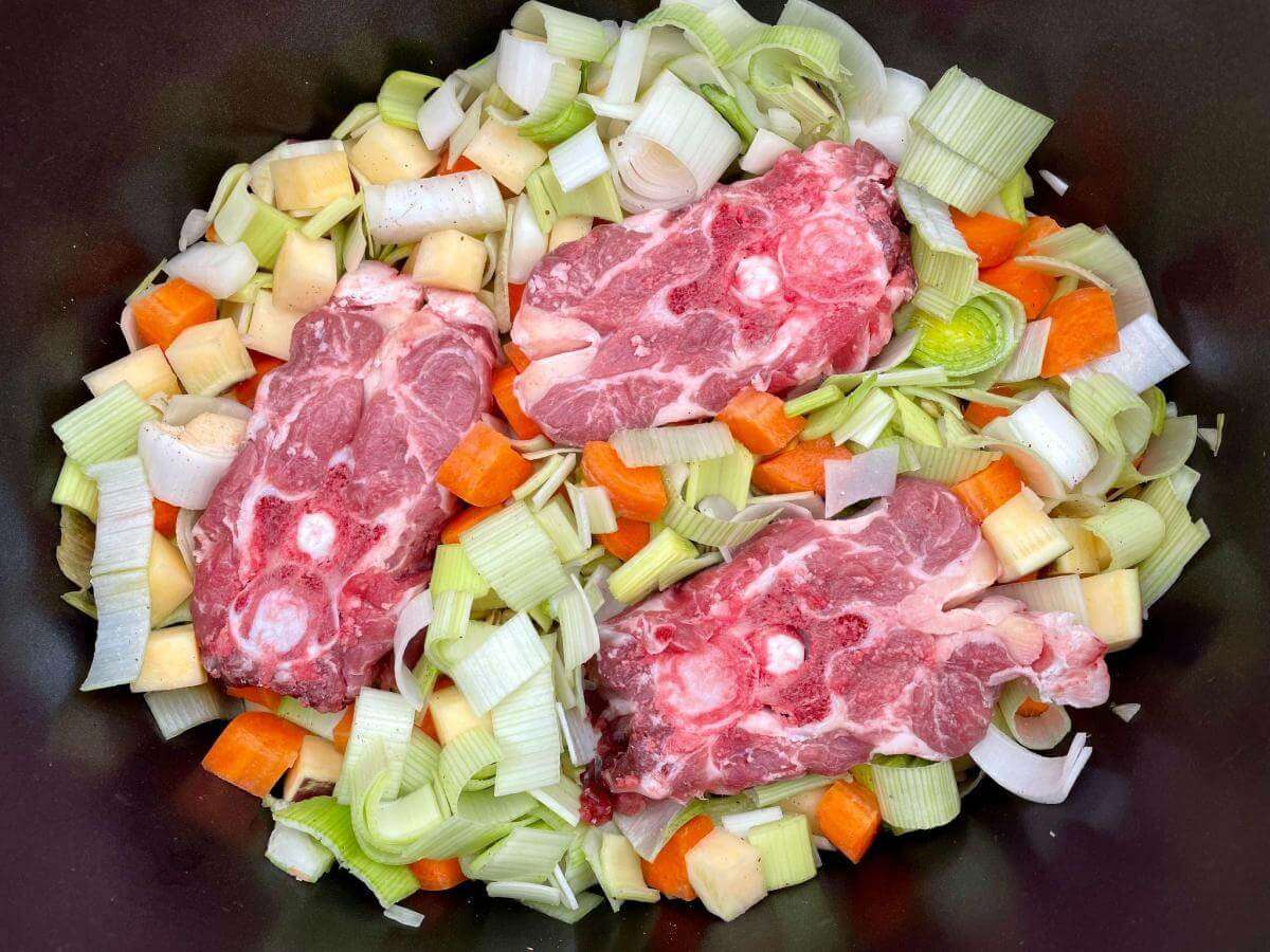 Lamb neck and vegetables in crock pot.