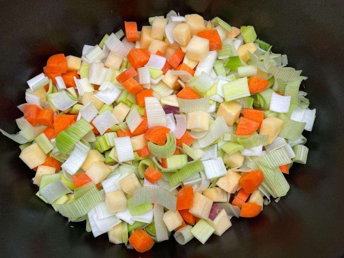 Carrot, leeks, onion and swede in slow cooker.
