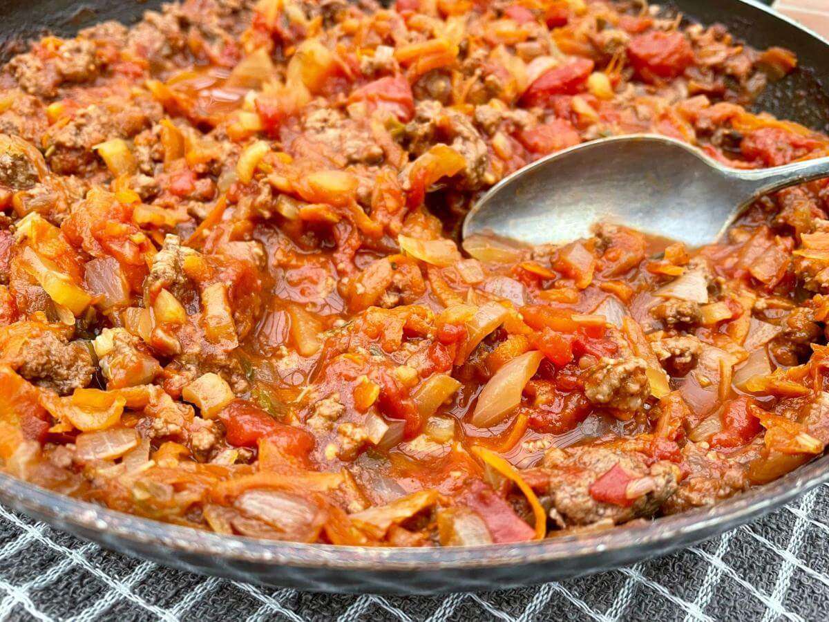 Gluten free bolognese with spoon.