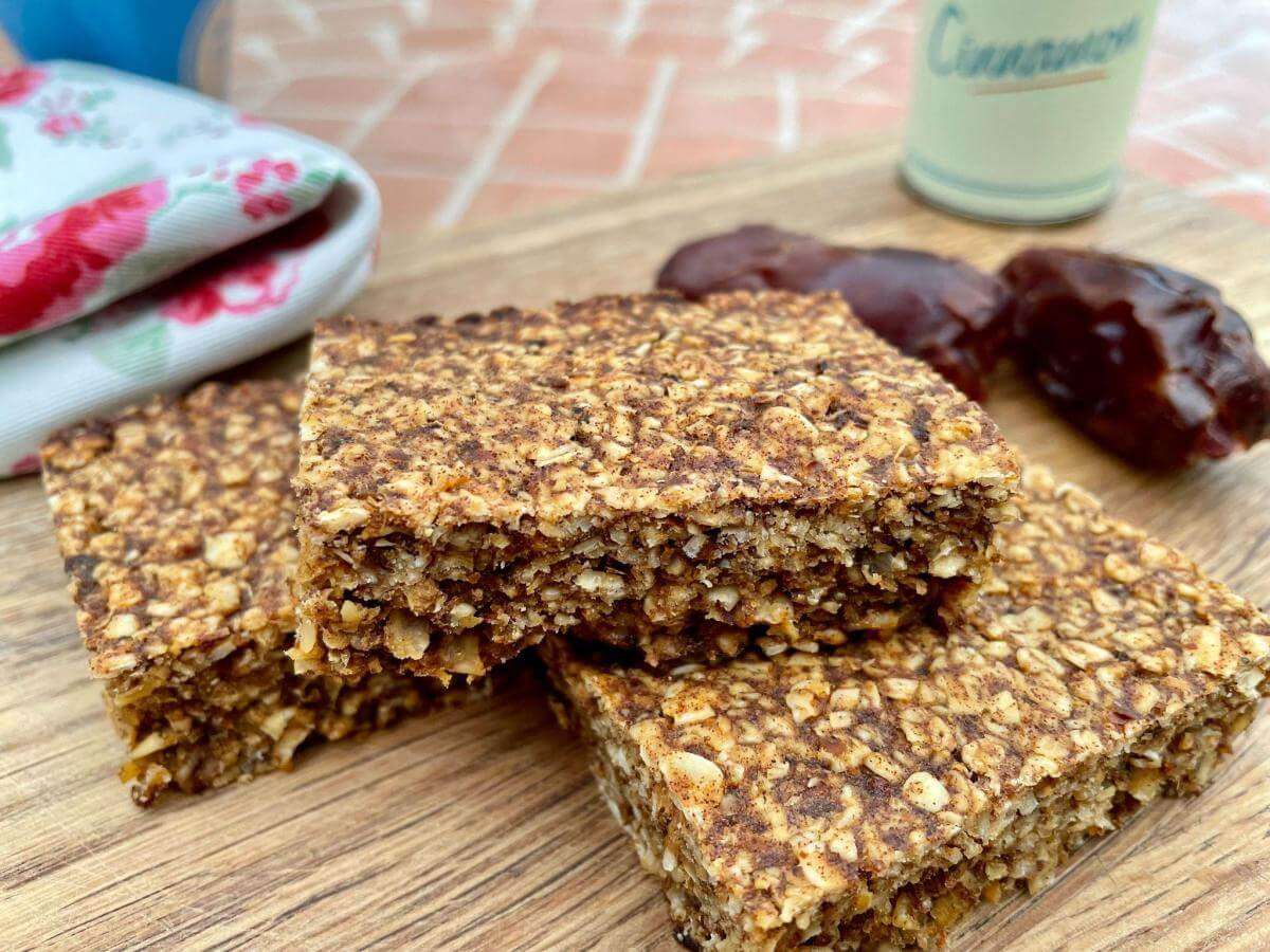 Healthy flapjacks with dates on wooden board.