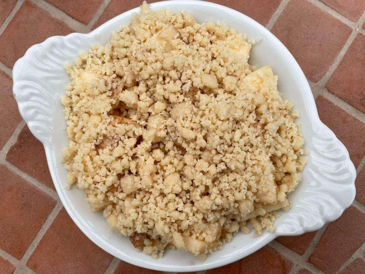 Uncooked crumble with coconut flour in dish.