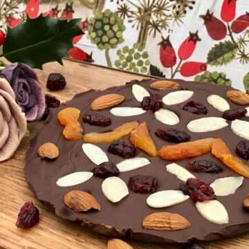 Round chocolate slab with almonds and apricots