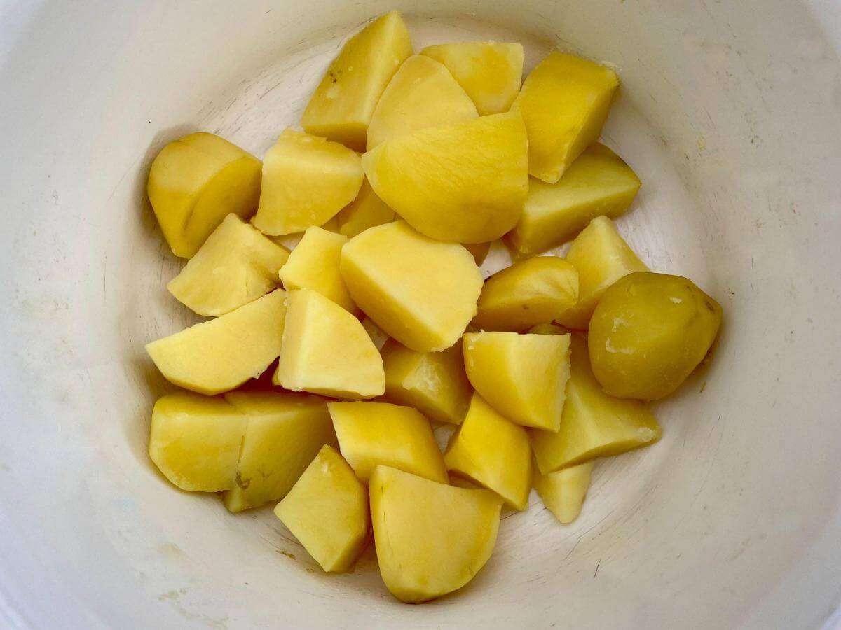 Cooked potatoes in pan.