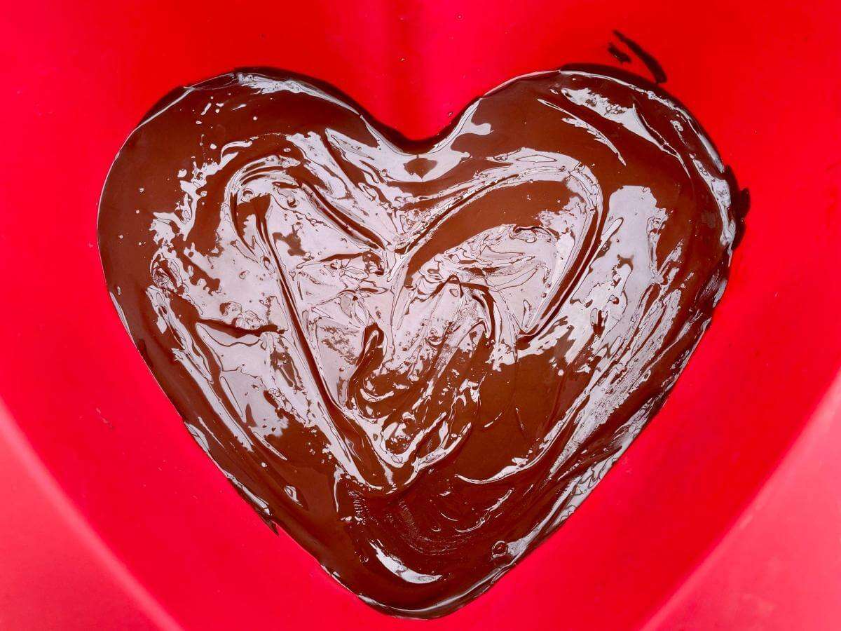 Melted chocolate in silicone heart mould.
