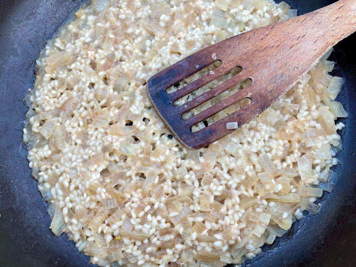 Rice and onions in pan.