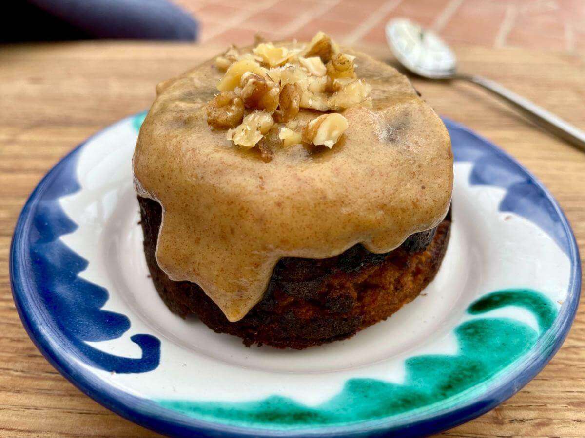 Healthy sticky date pudding with walnuts on top.