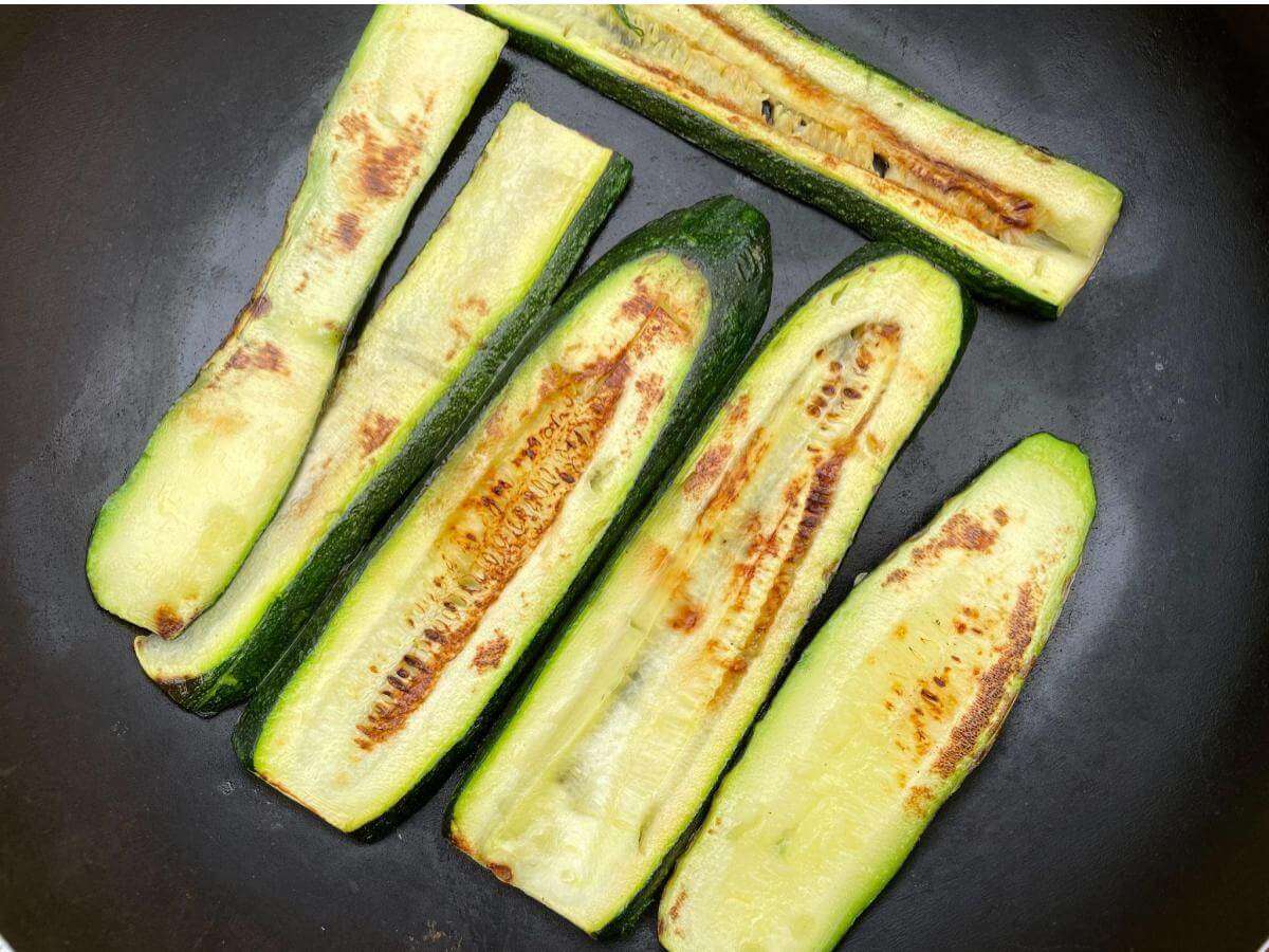 Browned courgettes in pan.