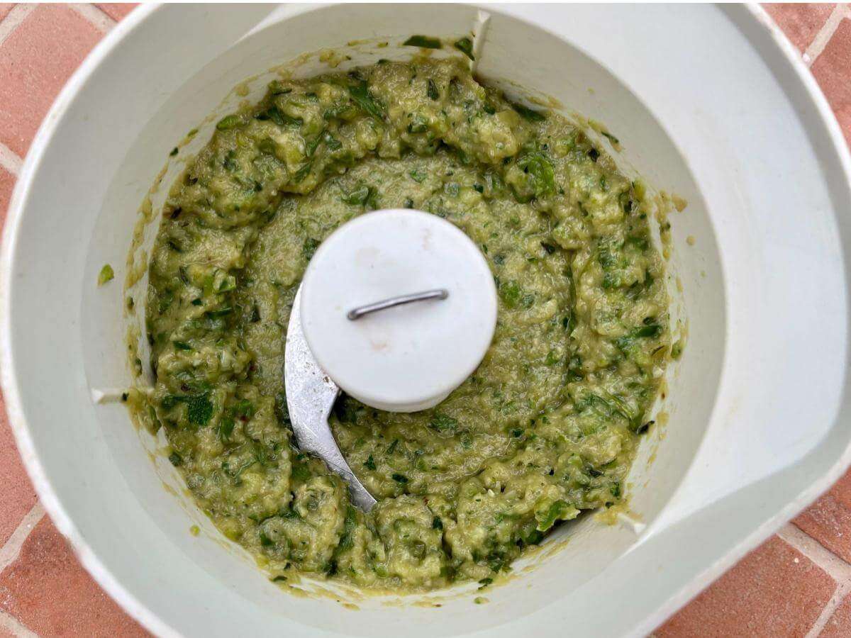Cooked courgettes and basil in food processor.