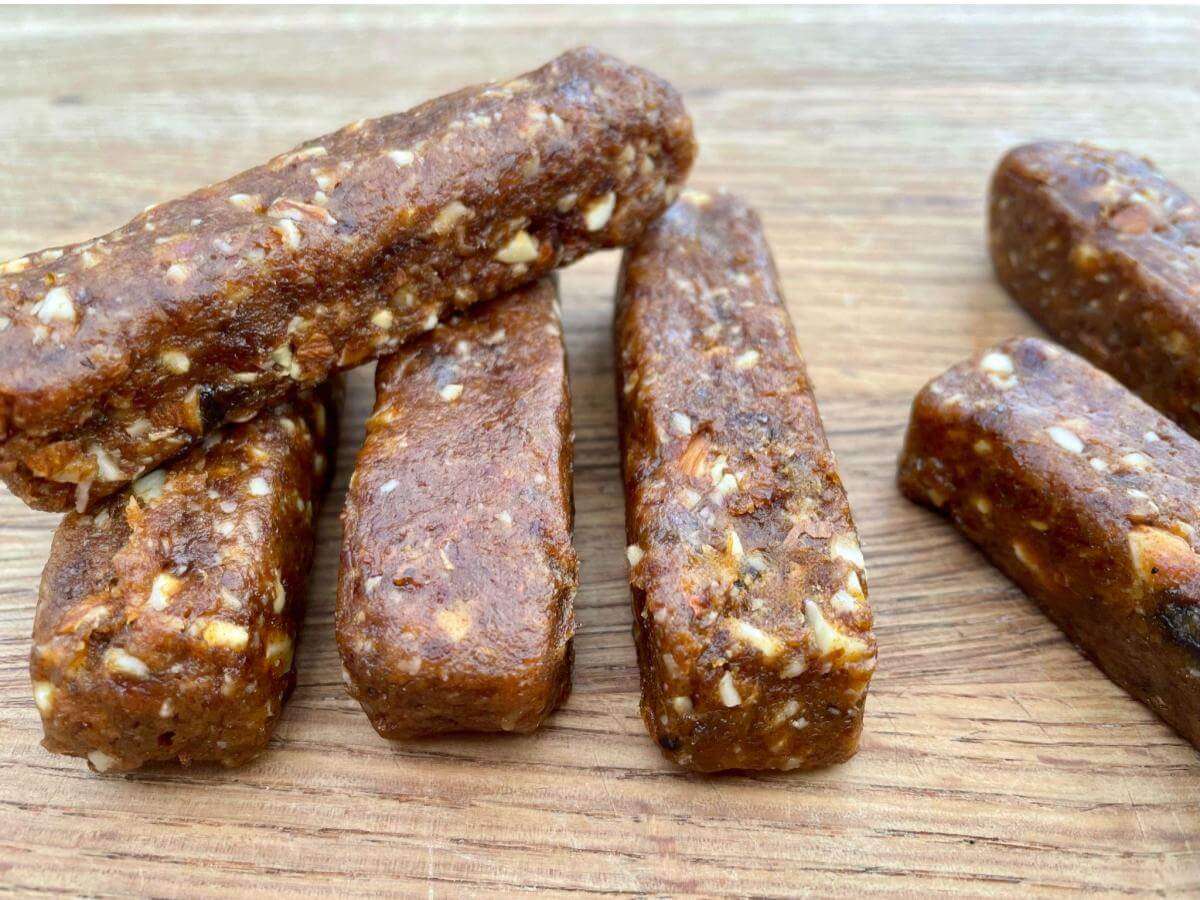 Homemade nakd bars on wooden board.
