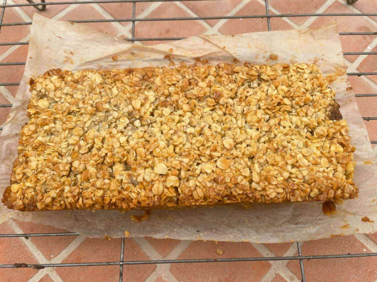 Apple and oat slices on wire rack.