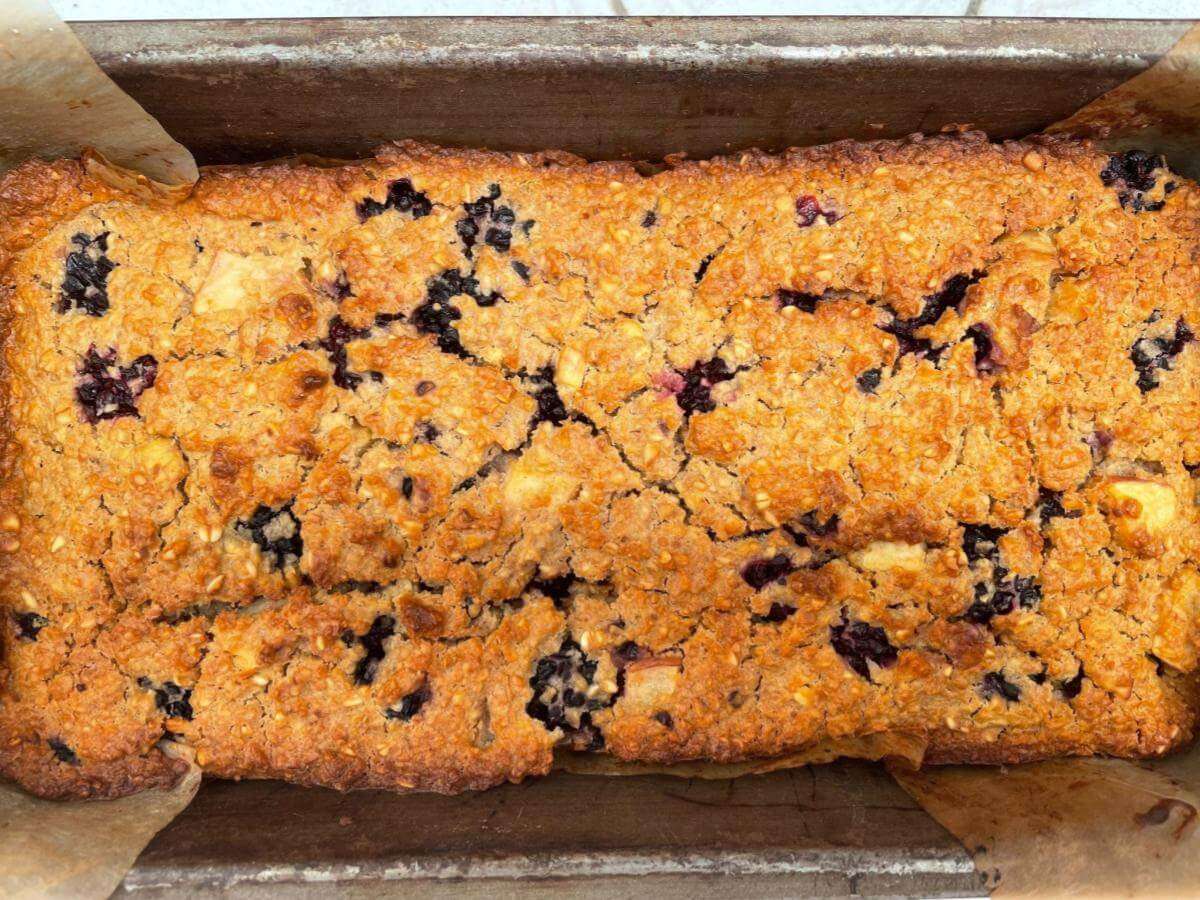 Baked apple and blackberry loaf in tin.