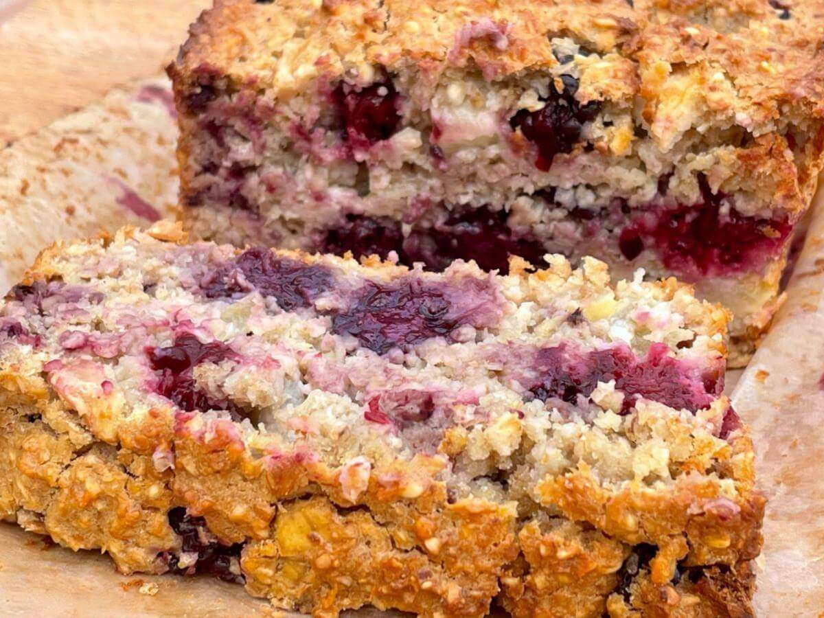 Slice of apple and blackberry loaf cake.