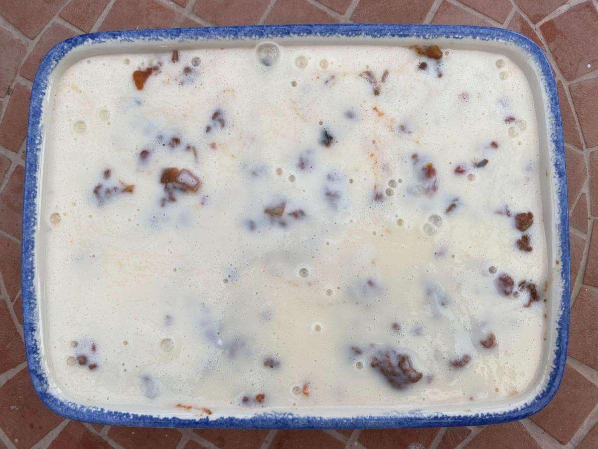 Uncooked moussaka in baking dish.