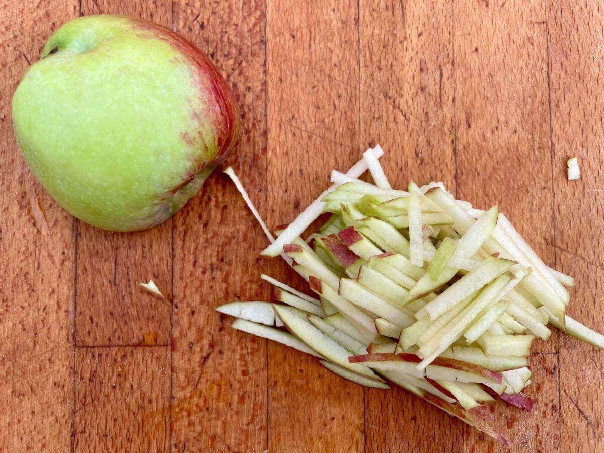Apple matchsticks on chopping board.